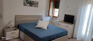 a small bedroom with a bed and a television at Villa Max in San Nicola Arcella