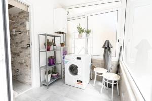 a laundry room with a washer and dryer at [APPIA Purple Terrace ] Apartment in Rome in Rome
