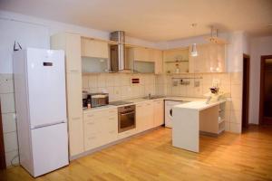 a kitchen with white appliances and a white refrigerator at Sadara Sea Breeze in Mamaia Sat/Năvodari