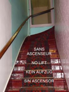 a staircase with a sign on the side of a building at Hotel des Belges in Paris