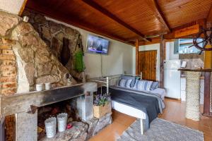 a living room with a stone fireplace and a couch at Lake House Buric in Vranjina