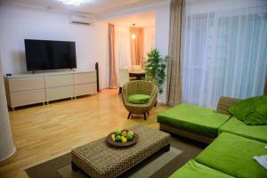 a living room with a couch and a flat screen tv at Sadara Sea Breeze in Mamaia Sat/Năvodari