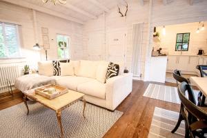 a living room with a white couch and a table at Firlands Cabin in Forres