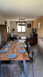 a large wooden table with wine glasses and chairs at Appartement Le Grand Duc in Gérardmer