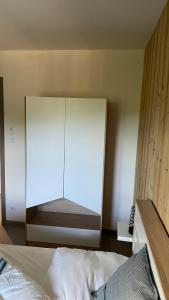 a bedroom with a bed and a large mirror at Appartement Le Grand Duc in Gérardmer
