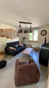 a living room with a couch and a table at Appartement Le Grand Duc in Gérardmer