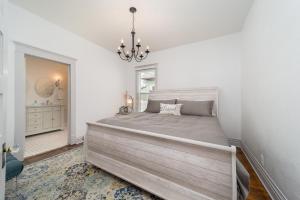 a bedroom with a large bed and a chandelier at Relax at this charming and cozy downtown retreat in Grand Junction