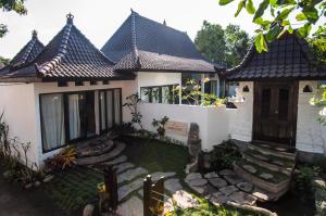 a house with a pathway in front of it at Ambary House Gili Trawangan- 2 BR Private Villa, Pool in Gili Trawangan