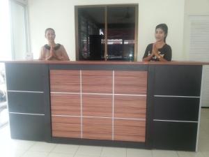 two women are standing at a counter in a room at The Green House in Kata Beach