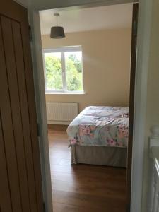 a bedroom with a bed and a window at Mourne country cottage in Warrenpoint
