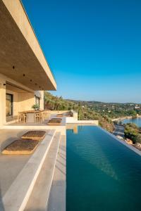 a swimming pool on the side of a house at My Poros in Poros