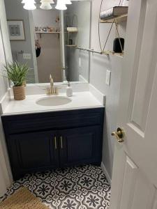 a bathroom with a sink and a mirror at Sleeps 20 6 BR Duplex near PD Canyon Dinning in Amarillo