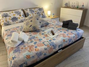 a bedroom with a bed with towels on it at ANGEL ROOM in Cagliari