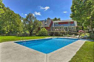 a swimming pool in the yard of a house at Decked-Out Home Hot Tub, Pool, Fire Pit and More! in Monroe