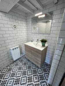 a bathroom with a sink and a mirror at HOSTEL PORTON in Lugo