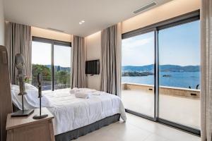 a bedroom with a bed and a view of the water at My Poros in Poros