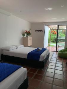 Rúm í herbergi á Hotel CSI Llanogrande
