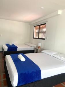 Rúm í herbergi á Hotel CSI Llanogrande