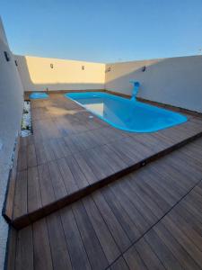 a swimming pool on the deck of a house at Balneário Céu Azul, com piscina a 350m da praia in Matinhos +15 photos