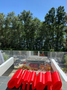 a red bench sitting on top of a balcony at ESPEJO DE SOLEDADES in Vigo de Sanabria