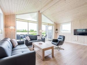 a living room with a couch and a table at Modern Retreat in Skaven - By Traum Ferienwohnungen in Tarm