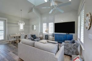 a living room with a couch and a tv at Green Turtle Cottage in Port Aransas