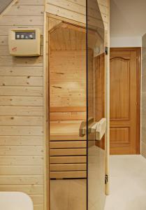 a sauna in a bathroom with wooden walls at Fresh penthouse apartment with great sea views in Casares