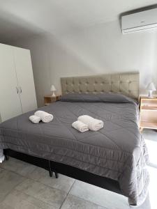 a bedroom with a bed with two pillows on it at Cba Rent in Cordoba