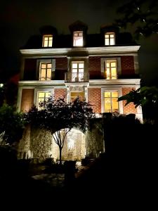 a large house with its lights on at night at Maison Loire in Blois