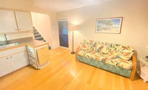 a living room with a couch and a kitchen at Black Sands Beach Condo with Full Kitchen in Pahala