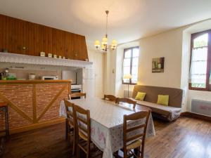 a living room with a table and a couch at Maison de village avec jardin, près de Villefranche du Périgord, idéale familles, animaux acceptés - FR-1-616-162 in Loubejac +11 photos