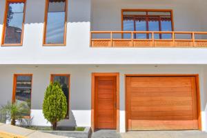 two wooden garage doors on a house at CASA TALIOS in Carhuaz