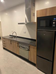 a kitchen with a black refrigerator and a microwave at Cantalar White in Anna