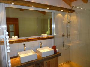 a bathroom with two sinks and a shower at DreiHäuser in Obergurgl