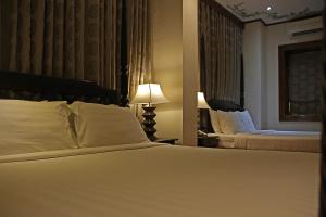 Hotel Veneto De Vigan tesisinde bir odada yatak veya yataklar