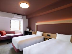 Postel nebo postele na pokoji v ubytování hotel androoms Naha Port