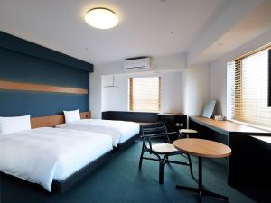 Postel nebo postele na pokoji v ubytování hotel androoms Naha Port