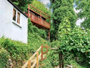 a wooden staircase leading up to a house with a balcony at Clooneavin Chalet in Lynmouth
