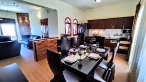 a dining room with a table and a kitchen at The Elysian at Nicopolis jacuzzi in Nikópolis