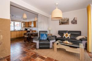 a living room with a couch and a table at Apartament z widokiem na morze U Grażyny 2 in Jarosławiec