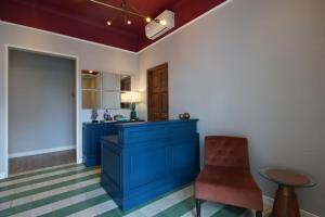 a kitchen with blue cabinets and a red chair at THE FOLK in Kejayan