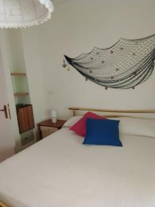 a bedroom with a bed with a hanging hammock above it at Palazzo tre palme in Follonica