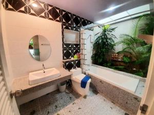 a bathroom with a sink and a toilet and a bath tub at Fancy Carp Resort Hua-Hin in Hua Hin