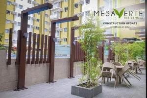 a patio with tables and chairs in front of a building at Lou- Mesaverte Residences in Cagayan de Oro