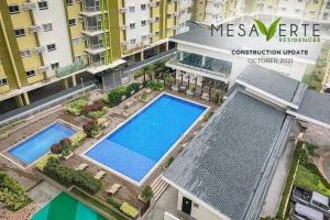 an overhead view of two swimming pools in a building at Lou- Mesaverte Residences in Cagayan de Oro