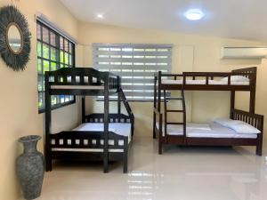 a room with three bunk beds and a mirror at Villa Marciana Farm in Bay Laguna Phase 2 in Franca