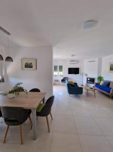 a living room with a table and chairs and a couch at Villa Manka in Umag