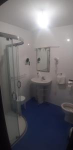a bathroom with a sink and a mirror and a tub at Hotel Rural La Curva Ribadesella in Ribadesella