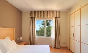 a bedroom with a bed and a window at Elviria Hills Living in Marbella +33 photos