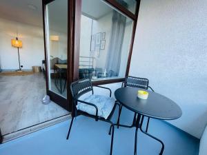 a small table and two chairs on a balcony at Apartment Sünnanbeter mit Pool für 2-4 Personen in Dahme